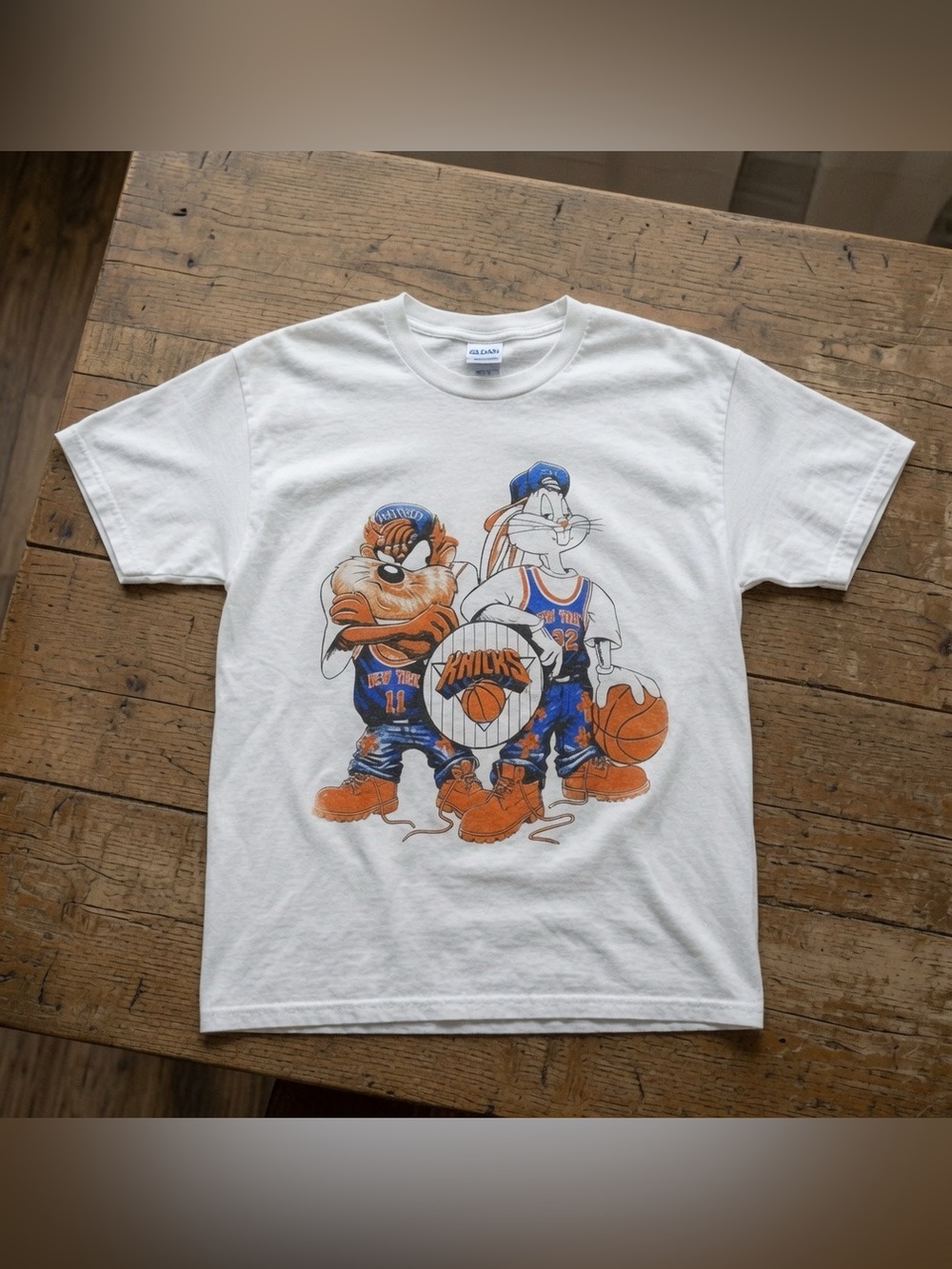 Gildan White Graphic Short Sleeve Tee with Blue & Orange Knicks Cartoon Design